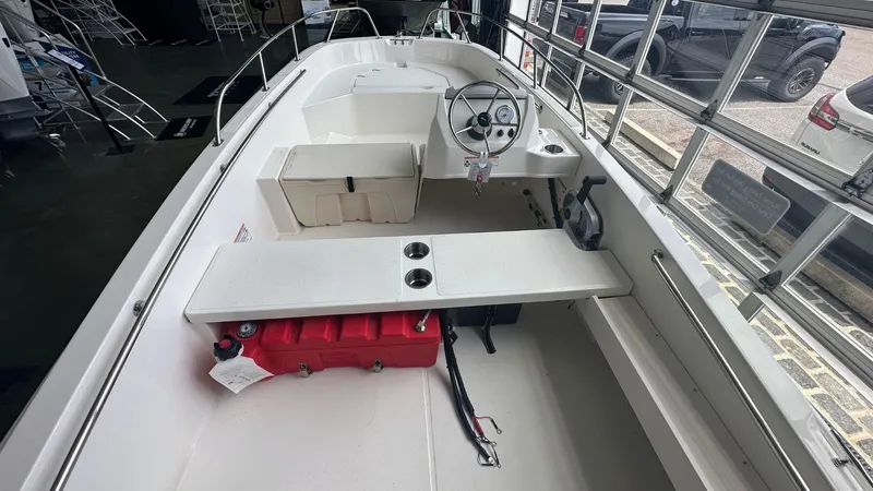 Slide: The Image of 2025 Boston Whaler 160 Super Sport interior with steering wheel and seating. - 7