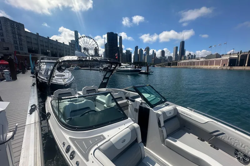 Slide: The Image of 2025 Regal LS6 Surf boat interior with sleek seating and modern design in a marina setting. - 7