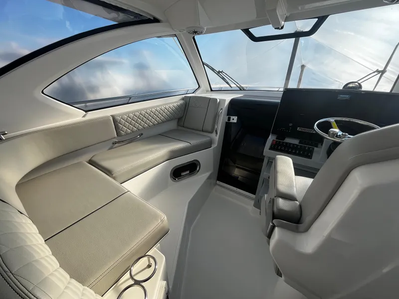 Slide: The Image of 2024 Pursuit OS 325 boat interior with modern helm and seating. - 10
