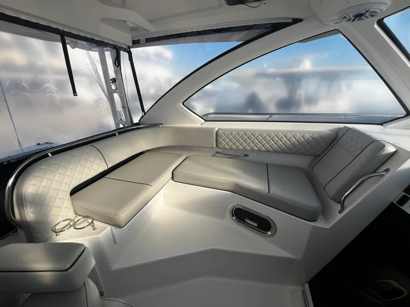 Slide: The Image of Luxurious interior of 2024 Pursuit OS 325 boat with elegant seating and panoramic windows. - 11