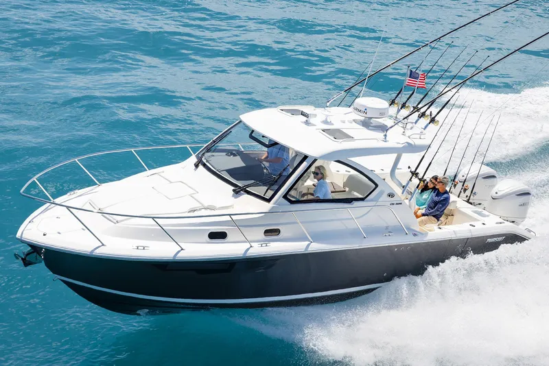 Slide: The Image of 2024 Pursuit OS 325 boat cruising on clear blue water. - 29
