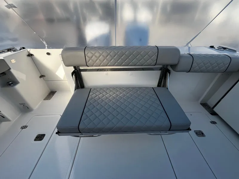 Slide: The Image of 2024 Pursuit OS 325 boat interior with quilted gray seating. - 3