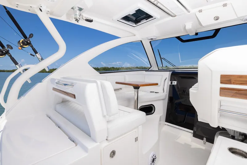 Slide: The Image of Interior of 2024 Pursuit OS 325 boat with white seating and fishing rods. - 34