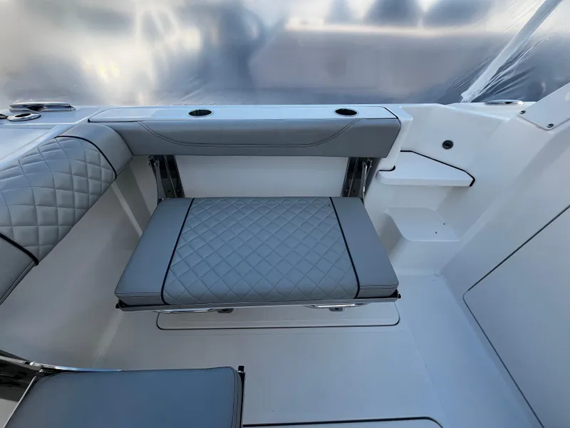 Slide: The Image of 2024 Pursuit OS 325 boat interior with quilted seating and modern design. - 4