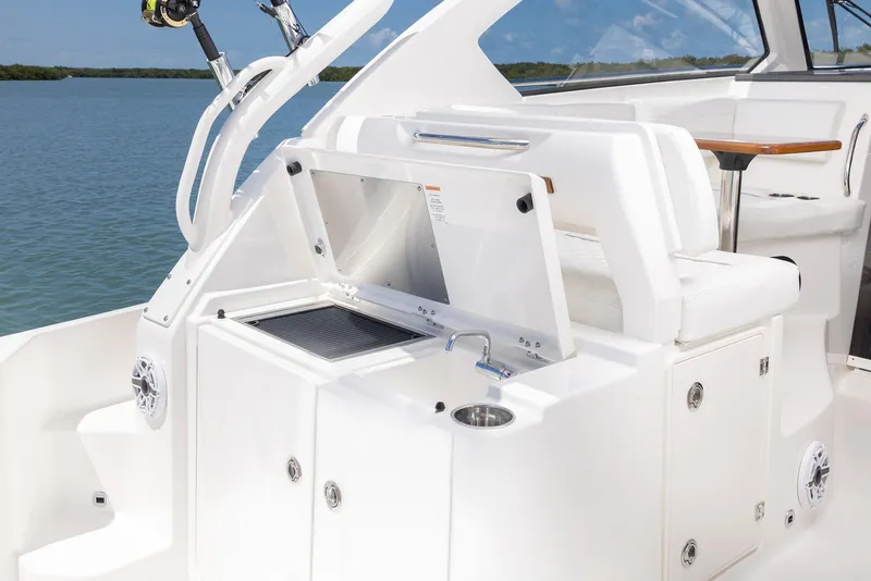 Slide: The Image of 2024 Pursuit OS 325 boat interior with sink and seating area. - 42