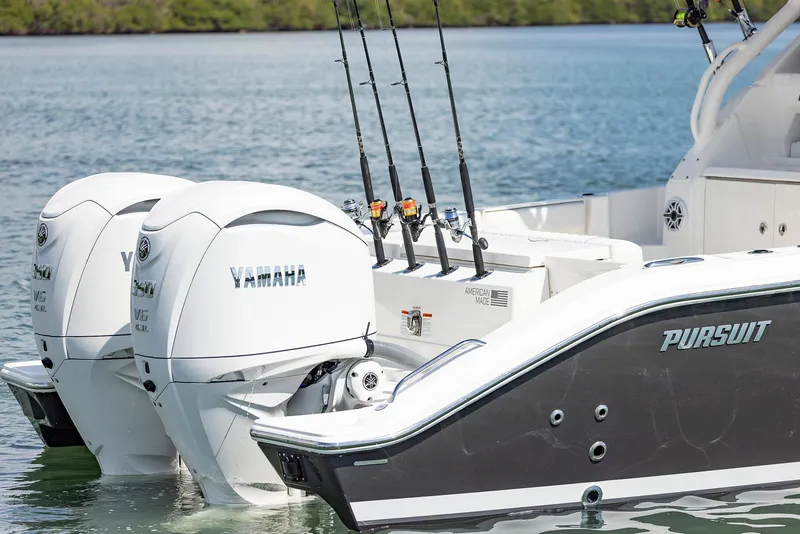 Slide: The Image of 2024 Pursuit OS 325 boat with Yamaha engines on a calm lake. - 45
