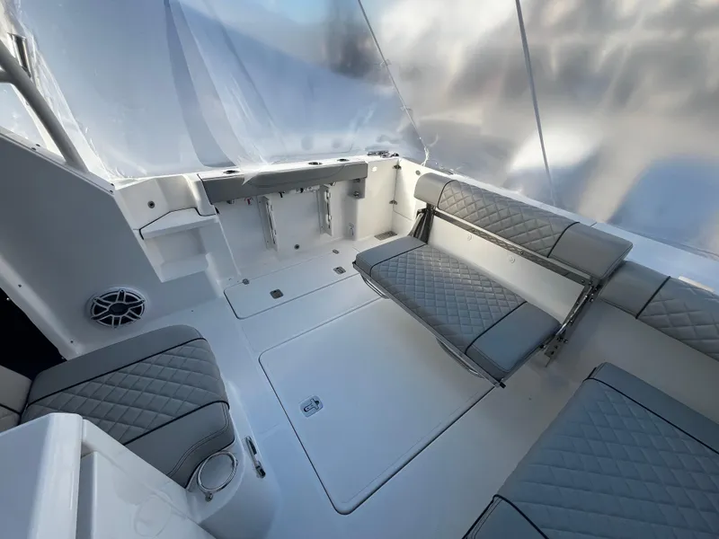 Slide: The Image of 2024 Pursuit OS 325 boat interior with quilted seating and sleek design. - 5