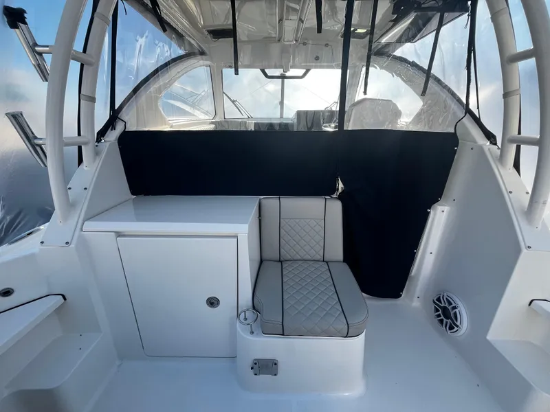 Slide: The Image of 2024 Pursuit OS 325 boat interior with seating and storage. - 6