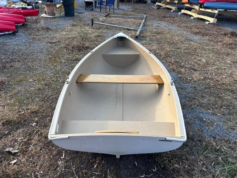 Slide: The Image of Puffin 860 boat, 2022 model, beige color, displayed outdoors on grass. - 3