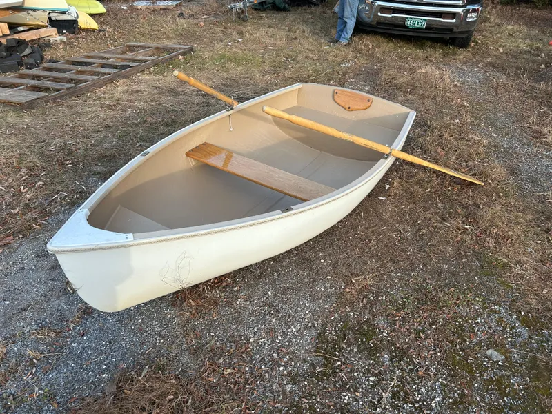 Slide: The Image of Small Puffin 860 rowboat with wooden oars on gravel, 2022 model. - 5