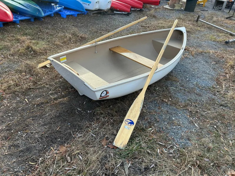 Slide: The Image of Small Puffin 860 rowboat with wooden oars on grassy ground, 2022 model. - 7