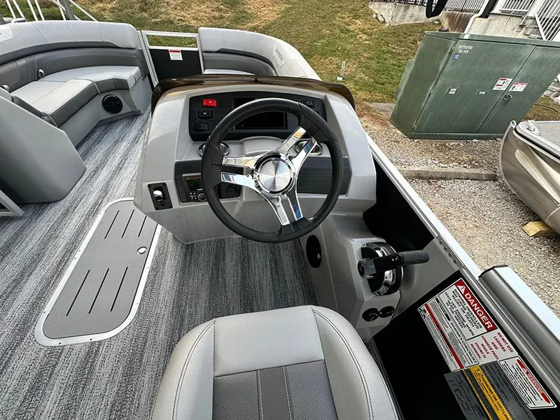 Slide: The Image of 2025 Bennington SX 22 Swingback boat interior with steering wheel and seating. - 1