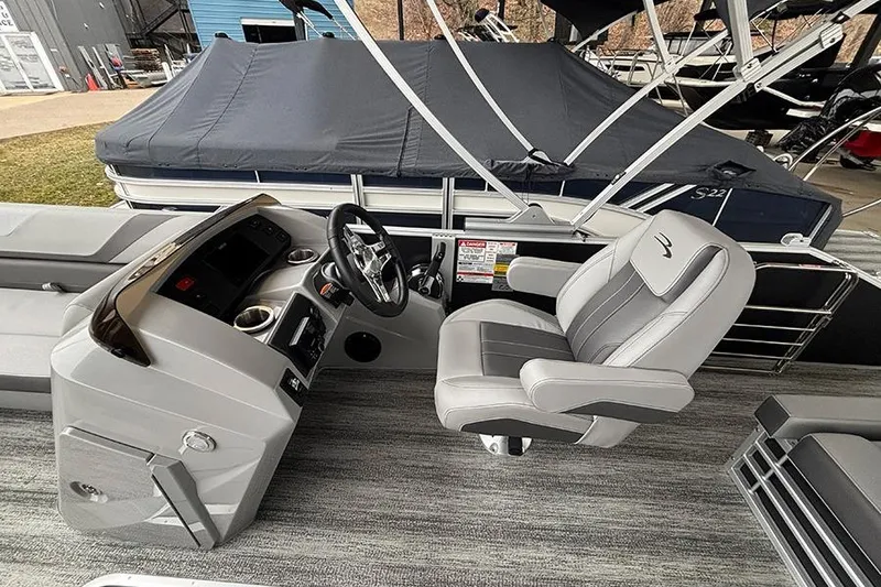 Slide: The Image of 2025 Bennington SX 22 Swingback boat with open storage compartment and cushioned seating. - 15