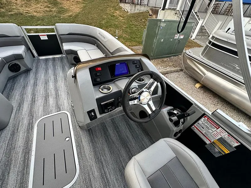 Slide: The Image of 2025 Bennington SX 22 Swingback boat interior with modern dashboard and seating. - 2
