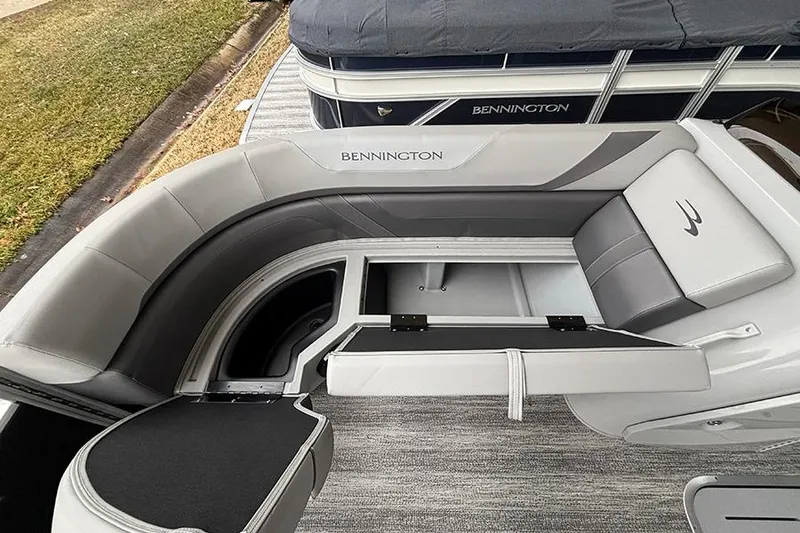 Slide: The Image of 2025 Bennington SX 22 Swingback with Mercury outboard motor in a covered marina. - 20