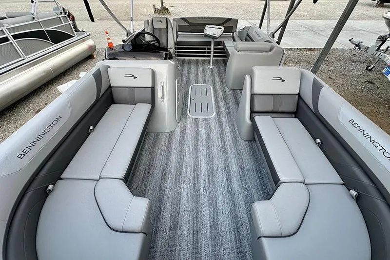 Slide: The Image of 2025 Bennington SX 22 Swingback pontoon boat interior with gray seating and flooring. - 4