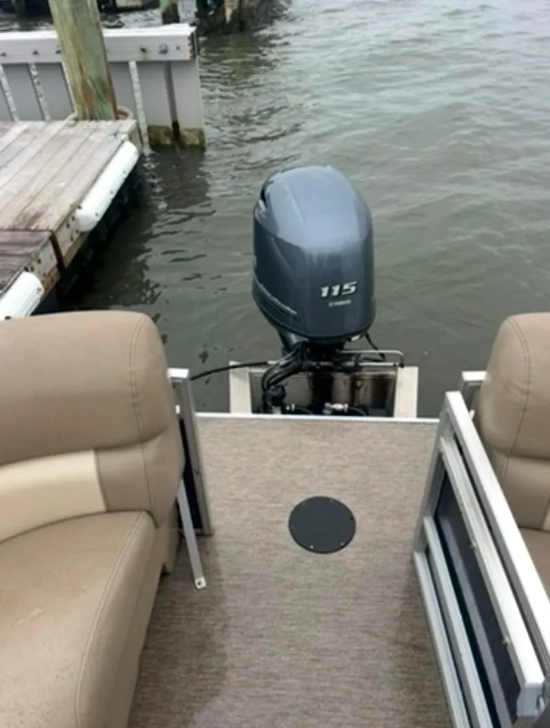 Slide: The Image of 2022 Starcraft LX 22 R pontoon boat with 115 HP outboard motor at dock. - 8