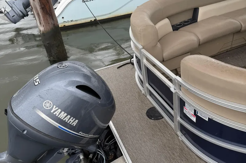 Slide: The Image of 2022 Starcraft LX 22 R pontoon boat with Yamaha motor, docked on water. - 9