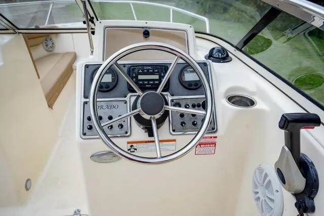 Slide: The Image of 2021 Scout 210 Dorado boat dashboard with steering wheel and controls. - 15
