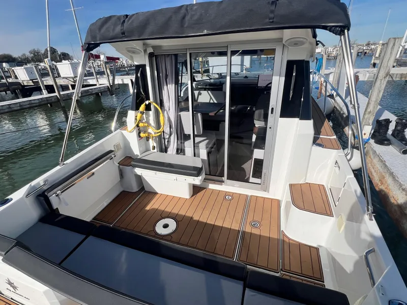 Slide: The Image of 2022 Jeanneau NC 795 S2 boat with teak deck and sliding glass doors at marina. - 19