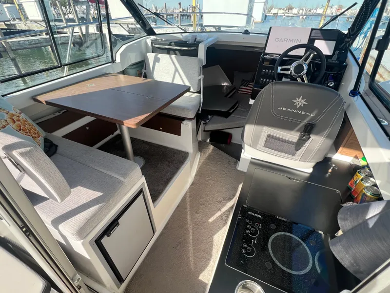 Slide: The Image of Interior of 2022 Jeanneau NC 795 S2 boat with seating, table, and helm. - 23