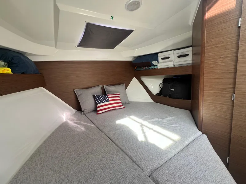Slide: The Image of Cozy cabin interior of 2022 Jeanneau NC 795 S2 with American flag pillow. - 31