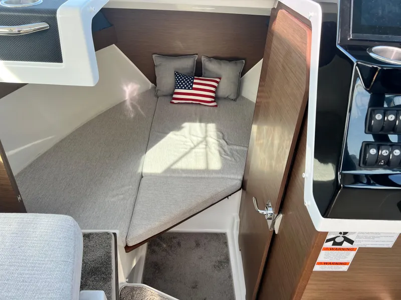 Slide: The Image of Cozy cabin interior of 2022 Jeanneau NC 795 S2 with American flag pillow. - 33