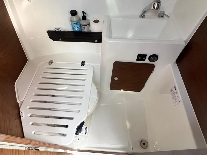 Slide: The Image of 2022 Jeanneau NC 795 S2 boat bathroom with sink, toilet, and storage. - 34