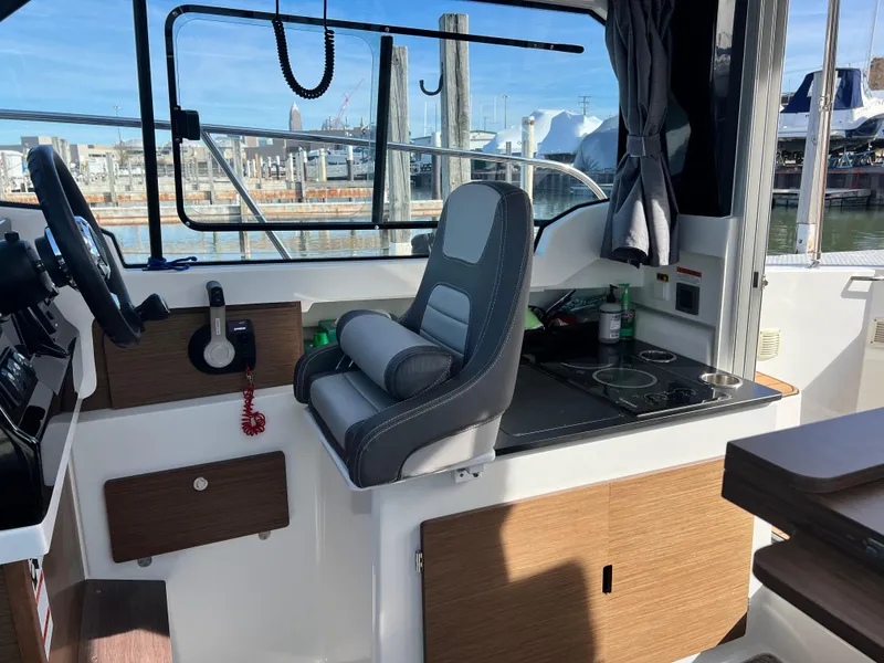 Slide: The Image of Interior of 2022 Jeanneau NC 795 S2 boat with helm and seating area. - 36