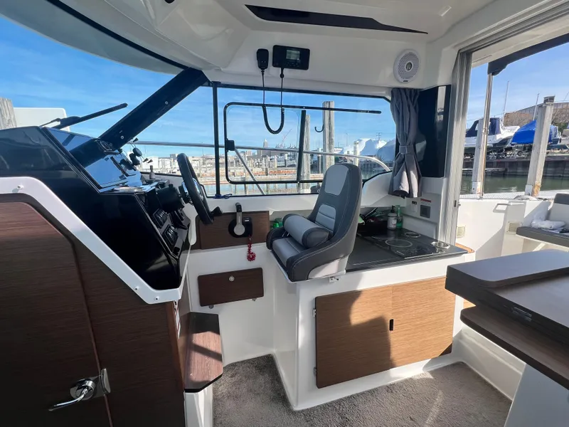 Slide: The Image of Interior of 2022 Jeanneau NC 795 S2 boat with helm and seating area. - 37