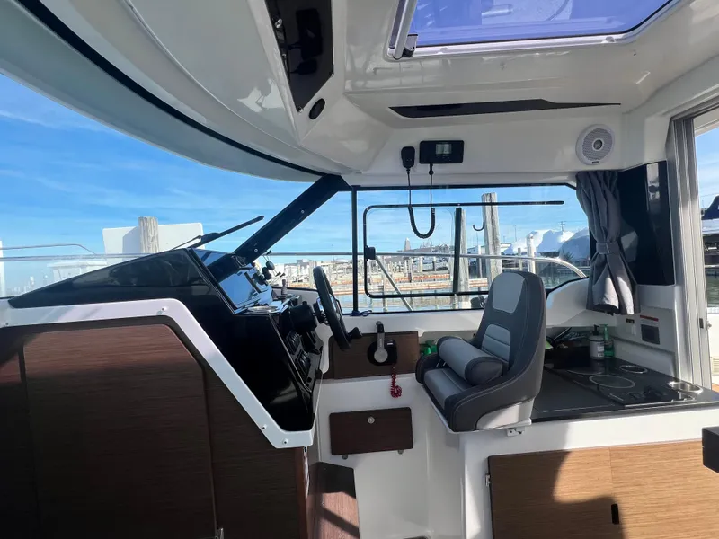 Slide: The Image of Interior of 2022 Jeanneau NC 795 S2 boat with helm and seating area. - 38
