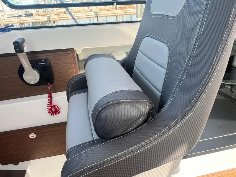 Slide: The Image of Captain's seat and controls of 2022 Jeanneau NC 795 S2 boat interior. - 39