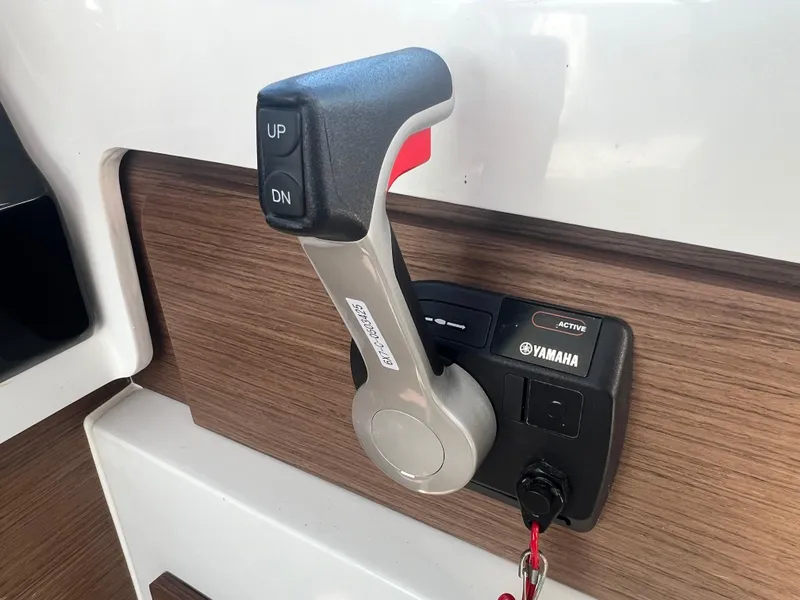 Slide: The Image of Yamaha throttle control on 2022 Jeanneau NC 795 S2 boat, featuring up and down buttons. - 40