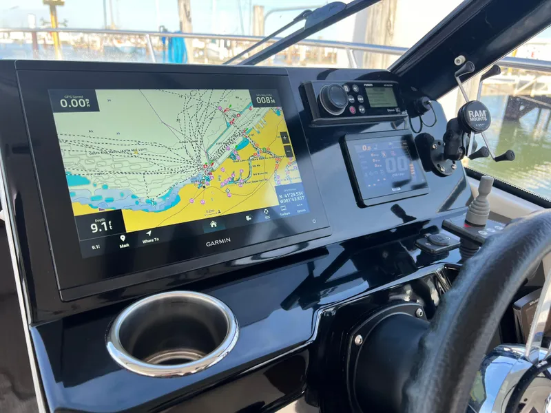 Slide: The Image of 2022 Jeanneau NC 795 S2 helm with Garmin navigation display and controls. - 42