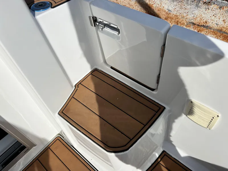Slide: The Image of 2022 Jeanneau NC 795 S2 boat deck with wood finish and storage compartment. - 47