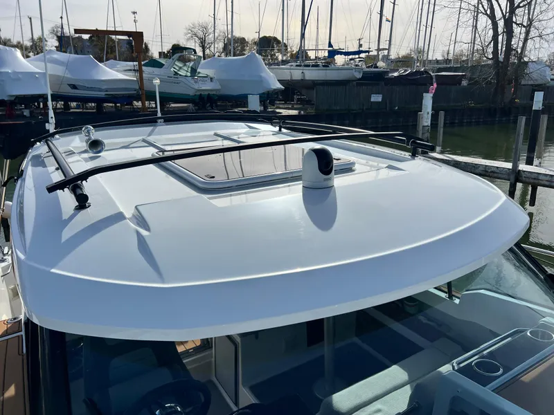 Slide: The Image of 2022 Jeanneau NC 795 S2 boat roof with mounted equipment in marina setting. - 48