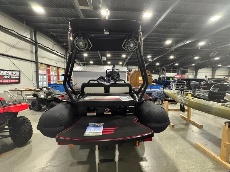 Slide: The Image of 2025 Highfield Velox 420 boat displayed indoors, showcasing rear view and equipment. - 2