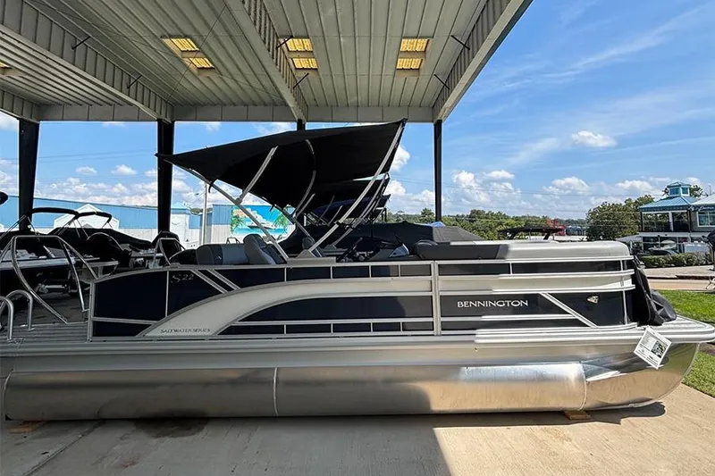 The Image of 2025 Bennington 22 S Swingback pontoon boat under a covered dock. - 0