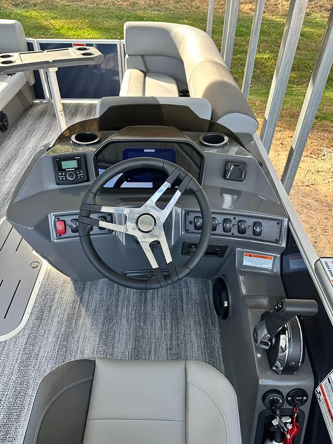 Slide: The Image of 2025 Bennington 22 S Swingback boat interior with modern steering console and seating. - 6
