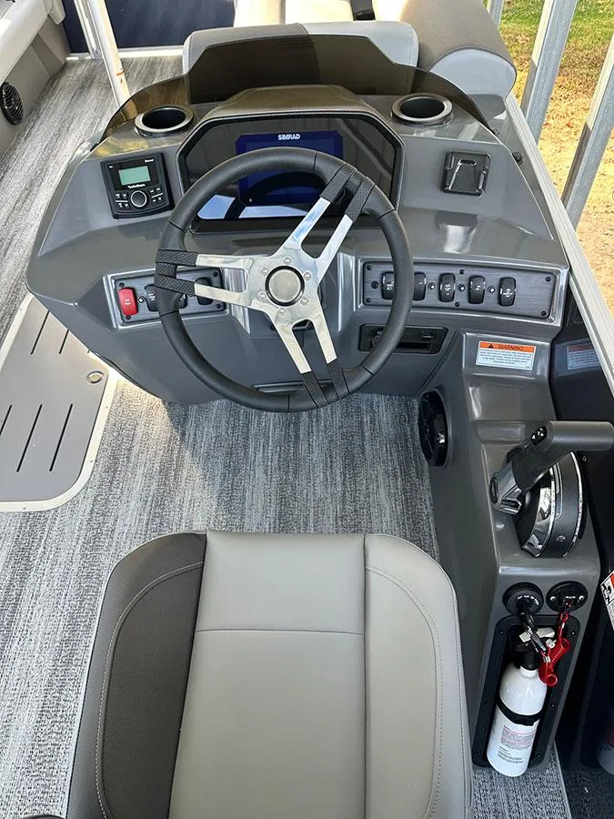 Slide: The Image of 2025 Bennington 22 S Swingback boat dashboard with steering wheel and controls. - 7