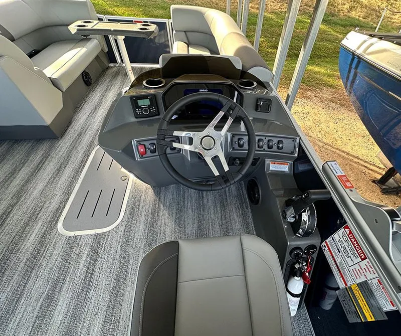 Slide: The Image of 2025 Bennington 22 S Swingback boat interior with modern helm and seating. - 9
