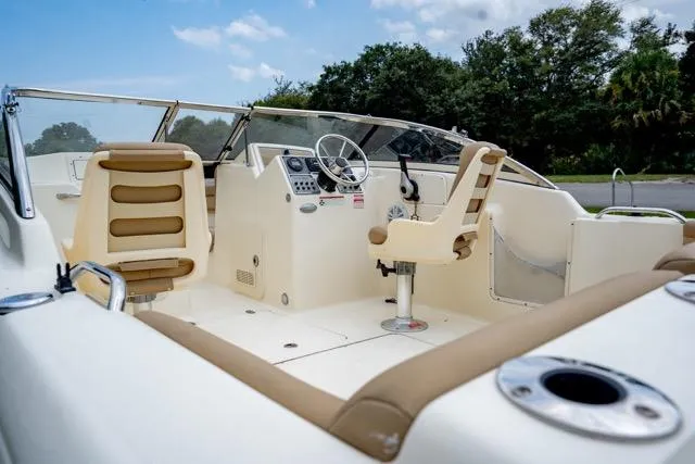 Slide: The Image of 2021 Scout 210 Dorado boat interior with steering wheel and seating. - 14
