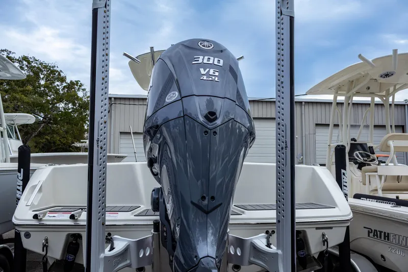 Slide: The Image of 2025 Pathfinder 2400 Open boat with powerful 300 V6 engine in marina setting. - 10