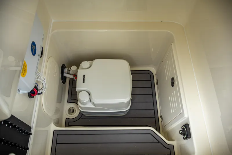 Slide: The Image of 2025 Pathfinder 2400 Open boat interior with compact marine toilet. - 26