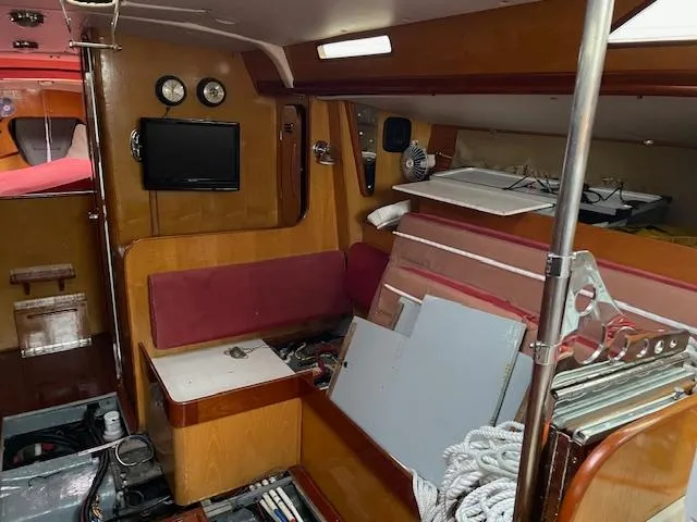 Slide: The Image of Interior of 1984 Farr 44 Custom sailboat with wood paneling and seating area. - 14
