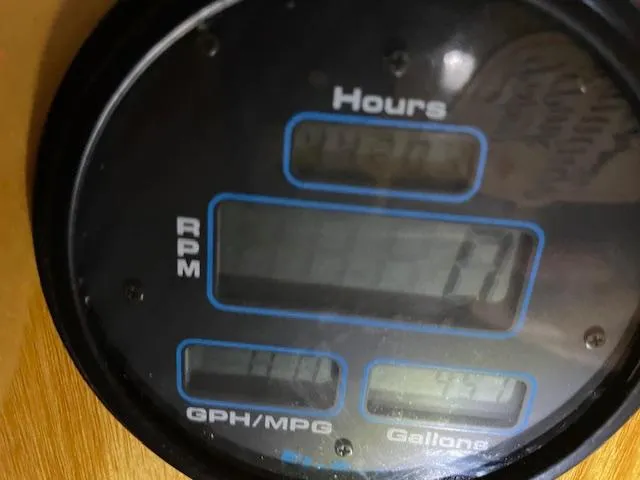 Slide: The Image of Close-up of a Farr 44 Custom 1984 boat gauge displaying hours, RPM, GPH/MPG, and gallons. - 15