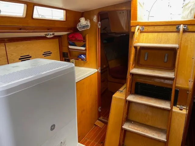 Slide: The Image of Interior of 1984 Farr 44 Custom sailboat with wooden cabinetry and compact layout. - 17