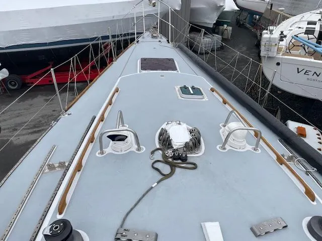 Slide: The Image of 1984 Farr 44 Custom sailboat deck with winches and ropes in a marina. - 20