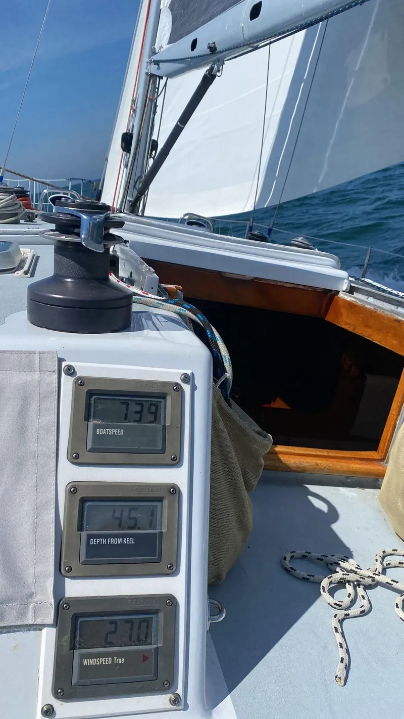 Slide: The Image of Sailing on a 1984 Farr 44 Custom yacht with digital navigation instruments displayed. - 3
