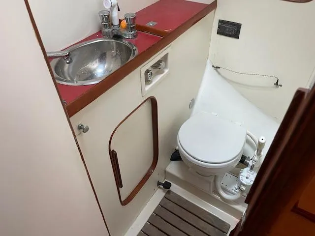 Slide: The Image of Compact bathroom in 1984 Farr 44 Custom yacht with sink and toilet. - 8